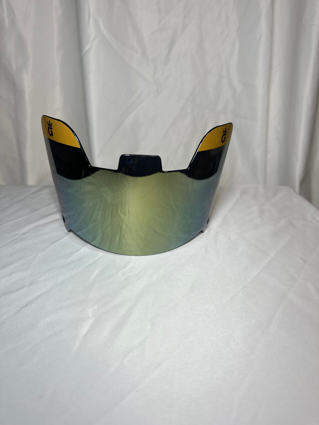 Helmet visor with reflective surface on a white background